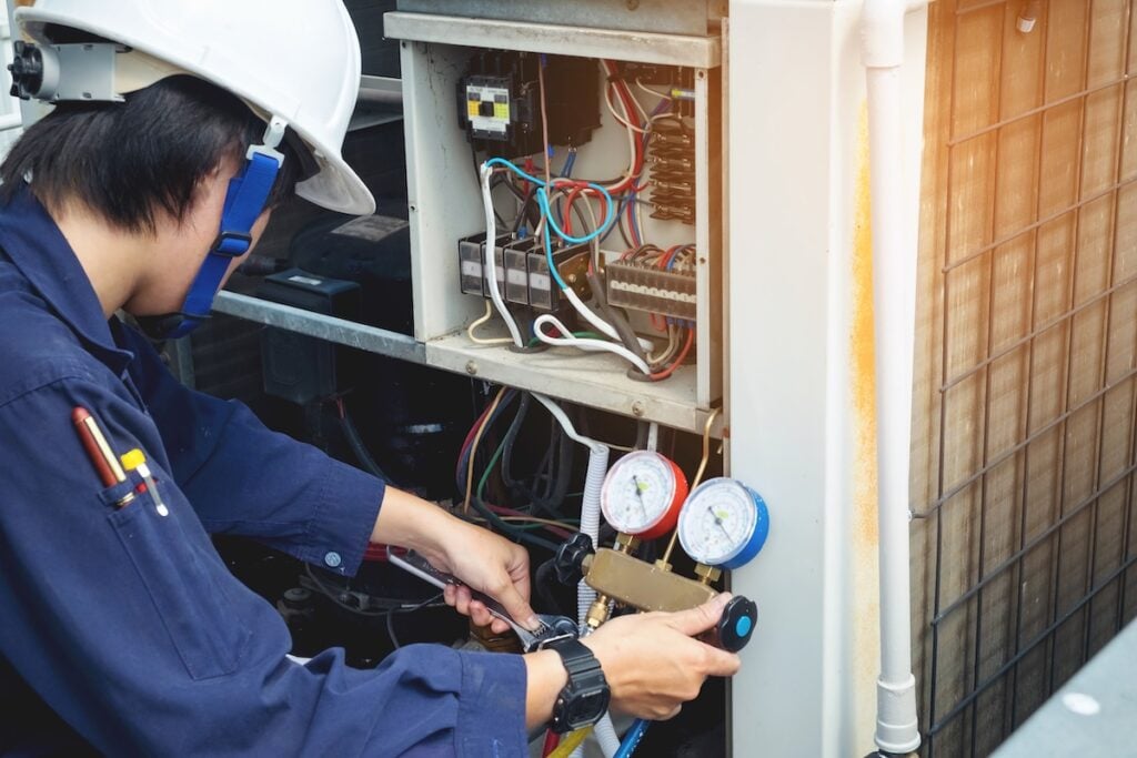 Technician is checking air conditioner commercial ac maintenance