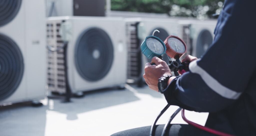 Technician is checking air conditioner ,measuring equipment for filling air conditioners.