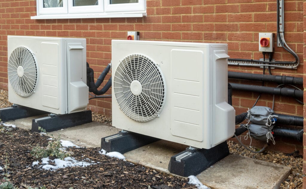 Two air source heat pump units installed on a modern house geothermal heat pump installation