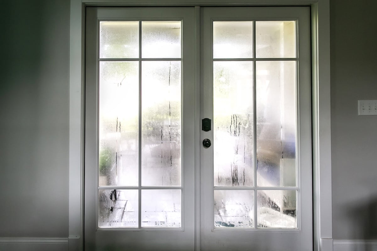 The humidity of the outdoor temperature on a summer day in South Georgia. The air conditioning is on inside and the cold air inside makes the back glass pane doors condensate and become foggy.