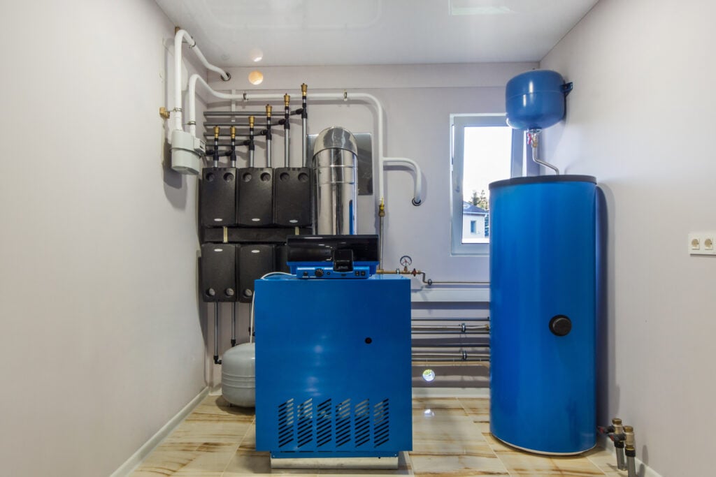 Gas Boiler room in a private house. Heating system with hot water thermal storage tank