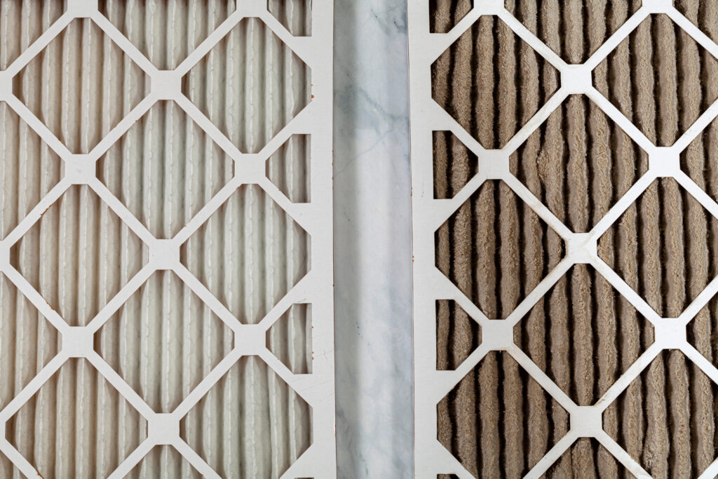 furnace filter replacement Side by side close up view of a new unused and an old heavily clogged dirty air filters. Image emphasizes the role of framed filters in improving air quality and preventing respiratory problems.