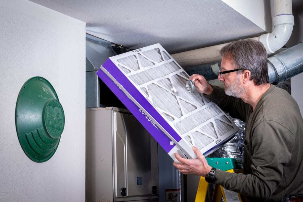 furnace filter replacement Resident inspects his filter for cleanliness