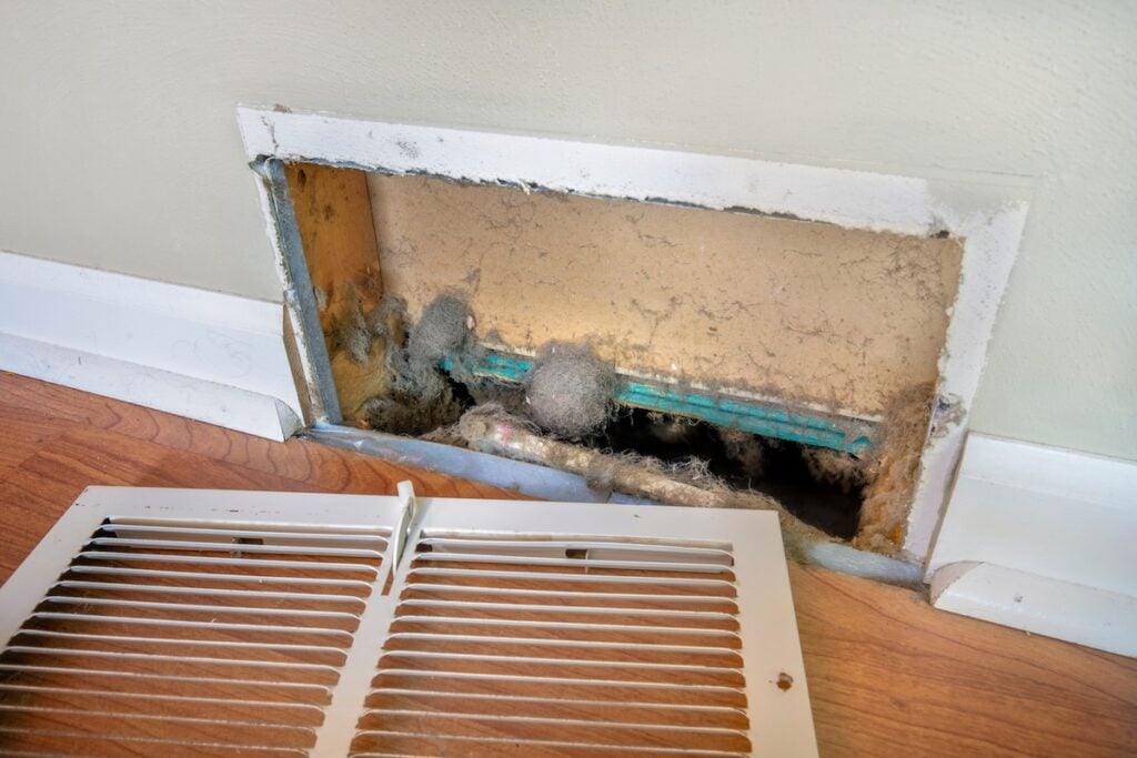 mold in air ducts Dirty register wall vent with dust clogging the duct opening in a home
