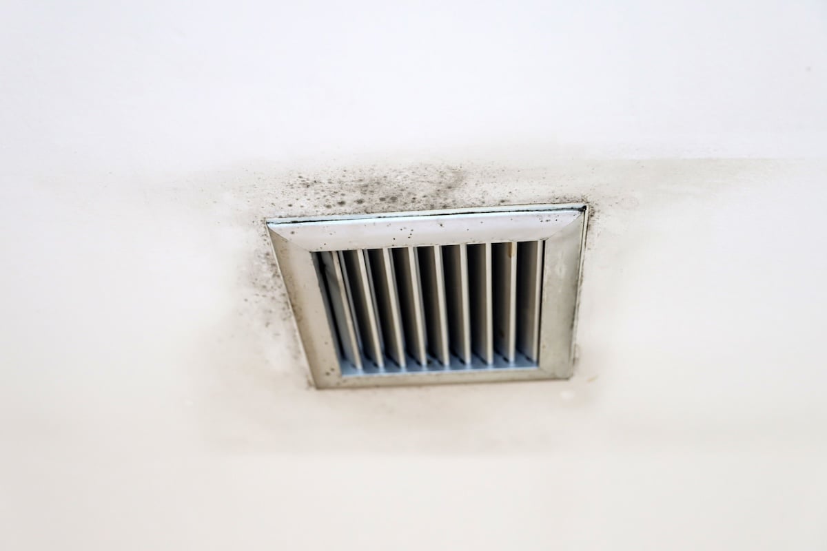 Water drop leak on air conditioner grille is ceiling stain and cracked and mold.