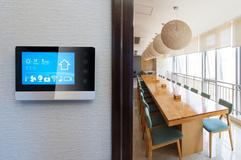 smart energy saving thermostat on a wall outside of modern cafeteria