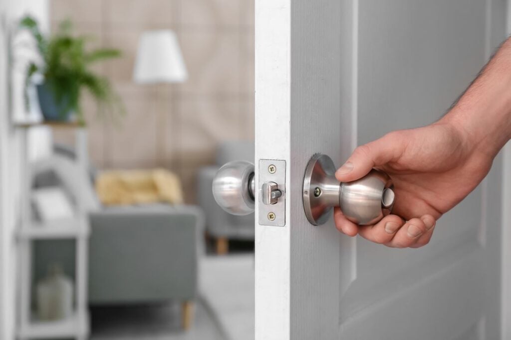 Man opening door at home