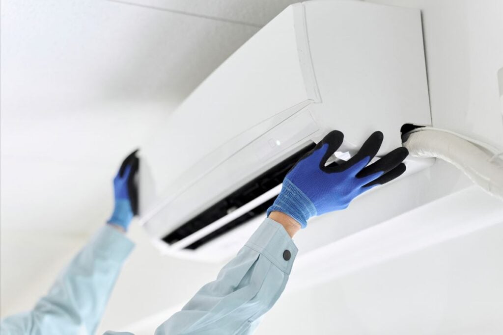 technician inspecting an AC unit
