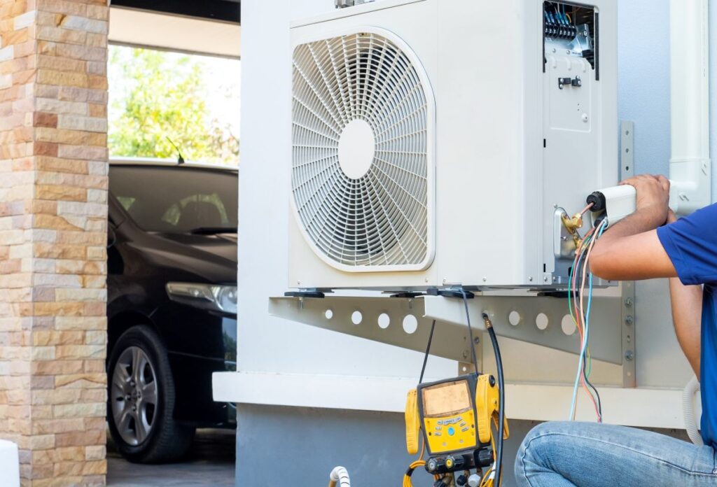 technician replacing AC compressor