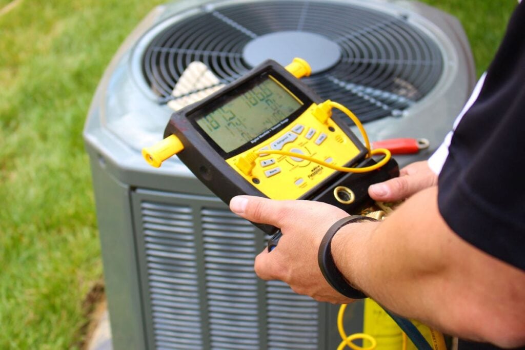 Heat Pump Heating cooling-services-rock-hill worker using tool
