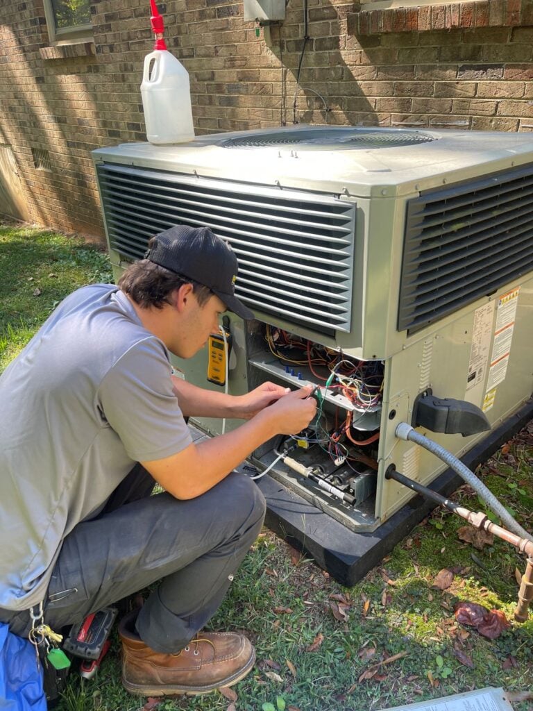 ac capacitor Panther HVAC worker repairing outdoor unit