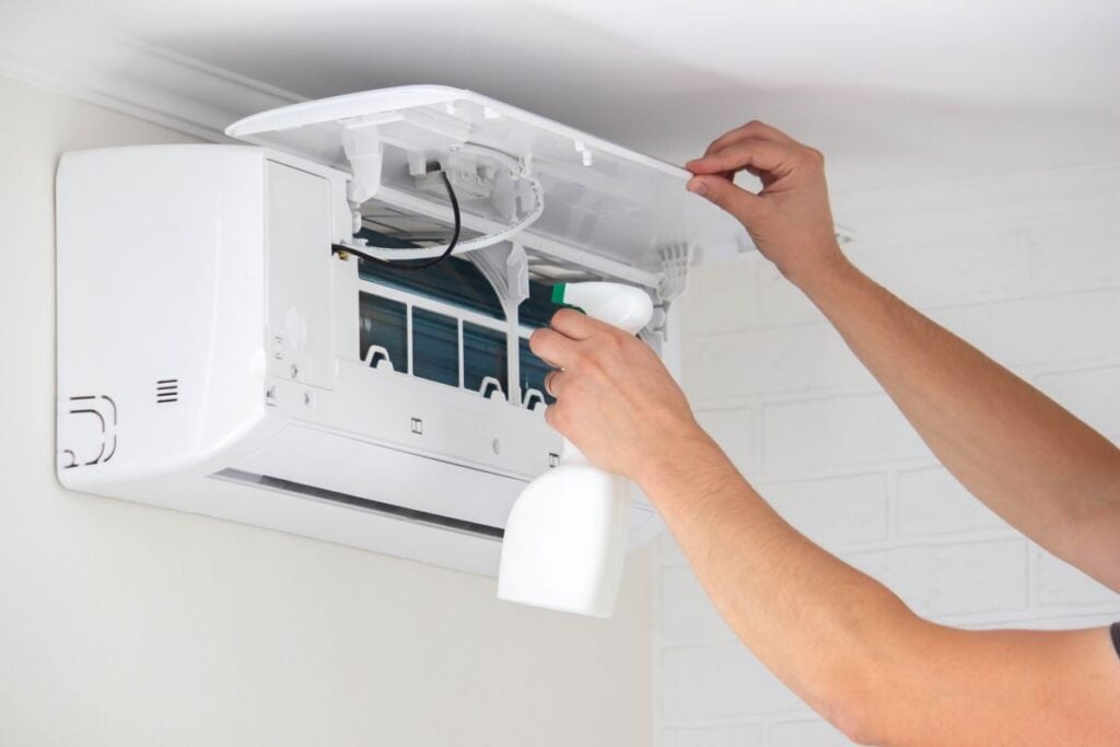 mold in air conditioner open hands cleaning with product