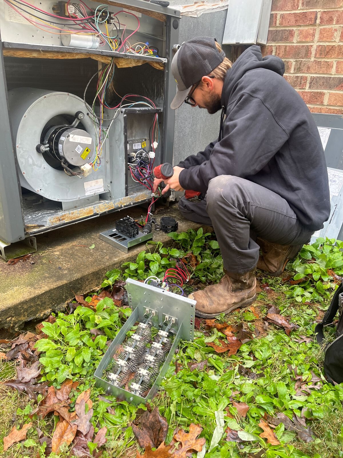 static pressure hvac worker repairing outdoor unit