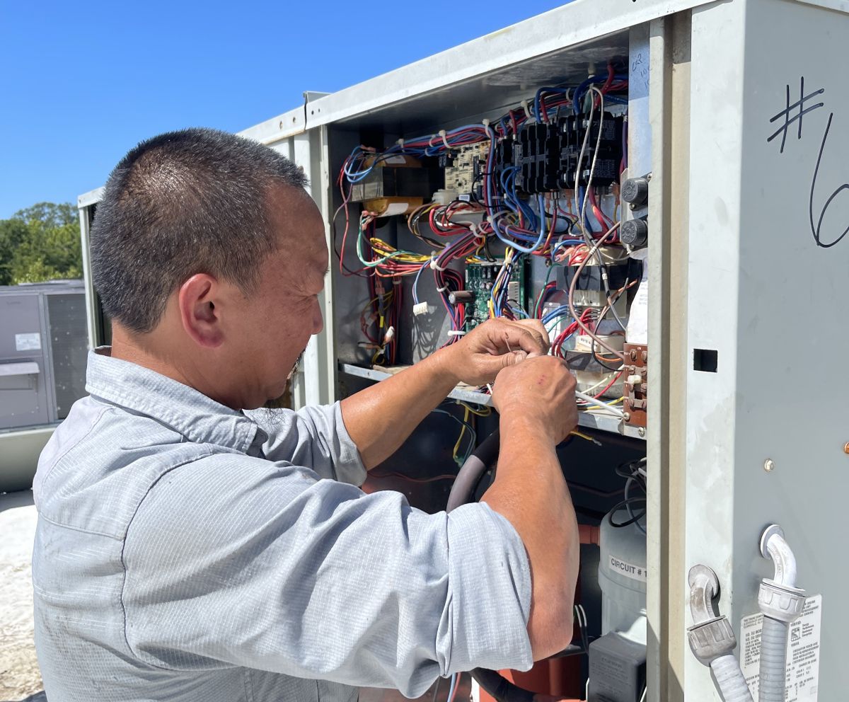 Panther HVAC team working and maintaining an AC unit