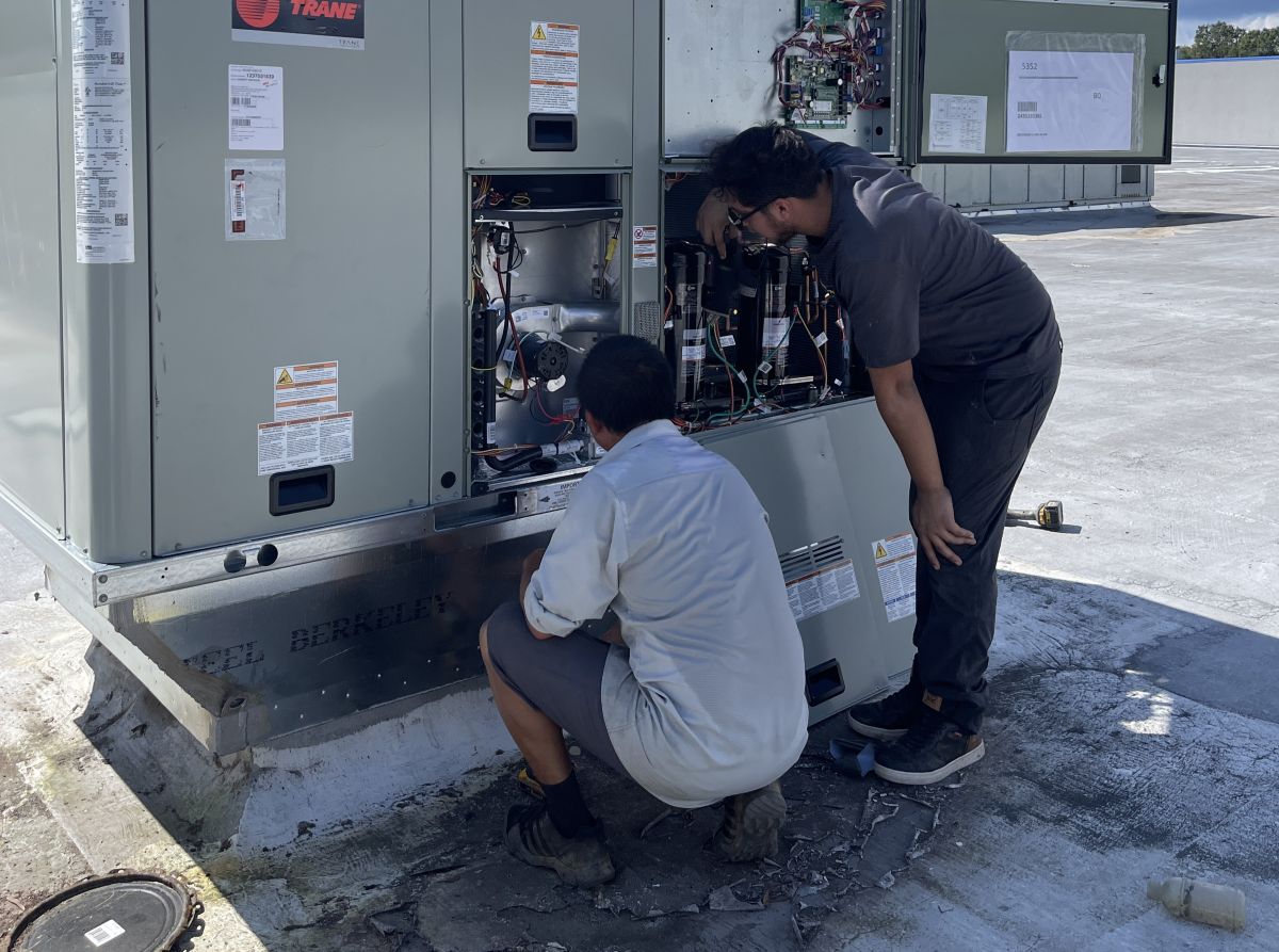 Panther HVAC team working on AC maintenance together