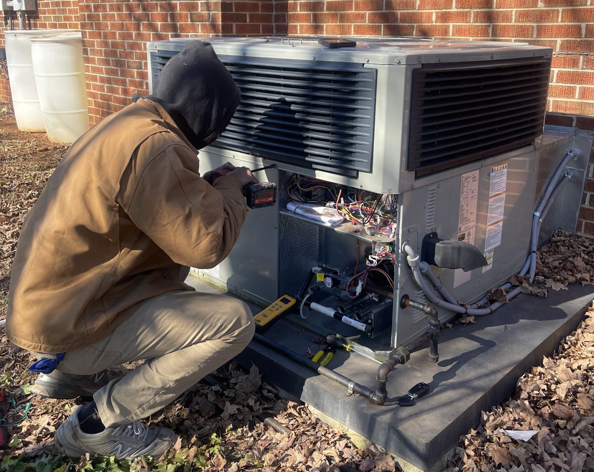 Panther HVAC team member working on AC maintenance
