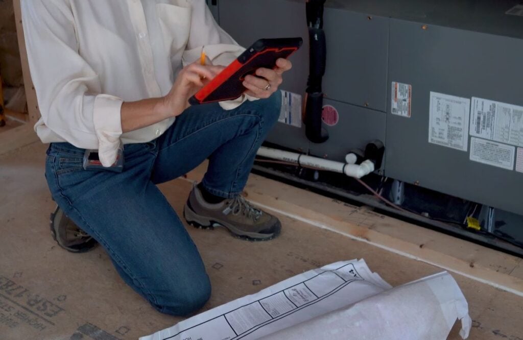 Mechanical engineer checking air conditioning unit in a new home construction