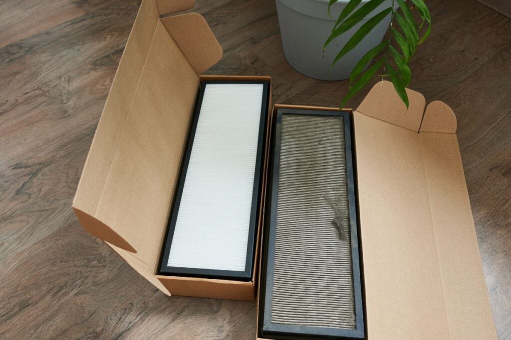 Old and new air filters in boxes. Air conditioning filters. Air purification system replacement.
