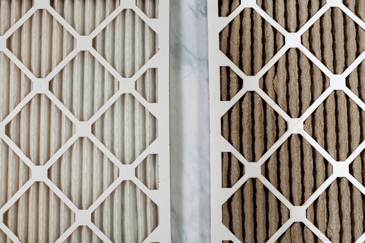 Side by side close up view of a new unused and an old heavily clogged dirty air filters