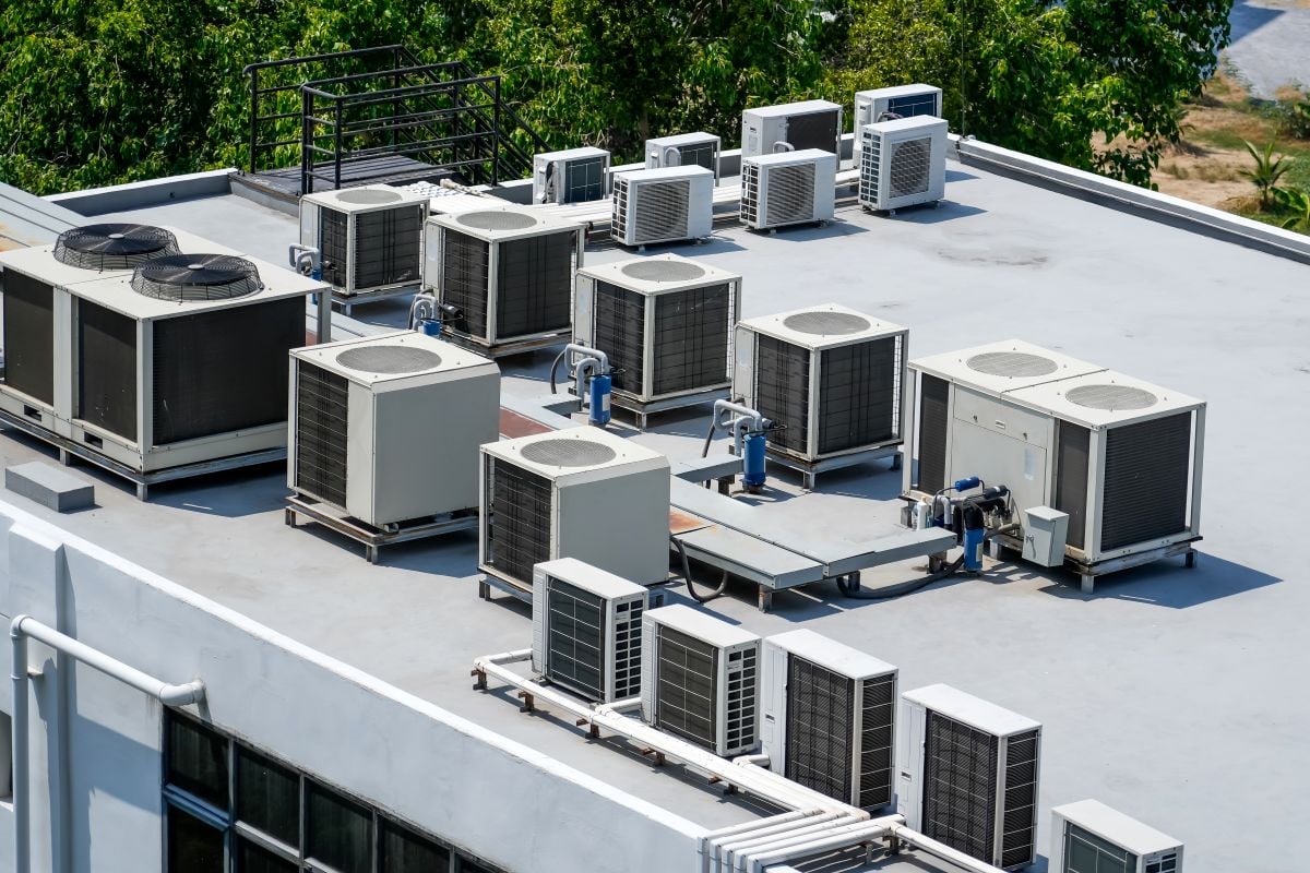 The external units of the commercial air conditioning and ventilation systems are installed on the roof of an industrial building