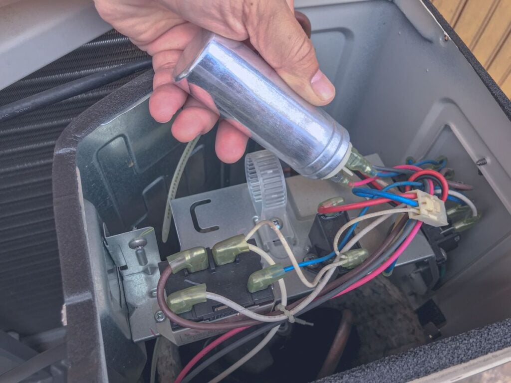 Hand holding the capacitor run