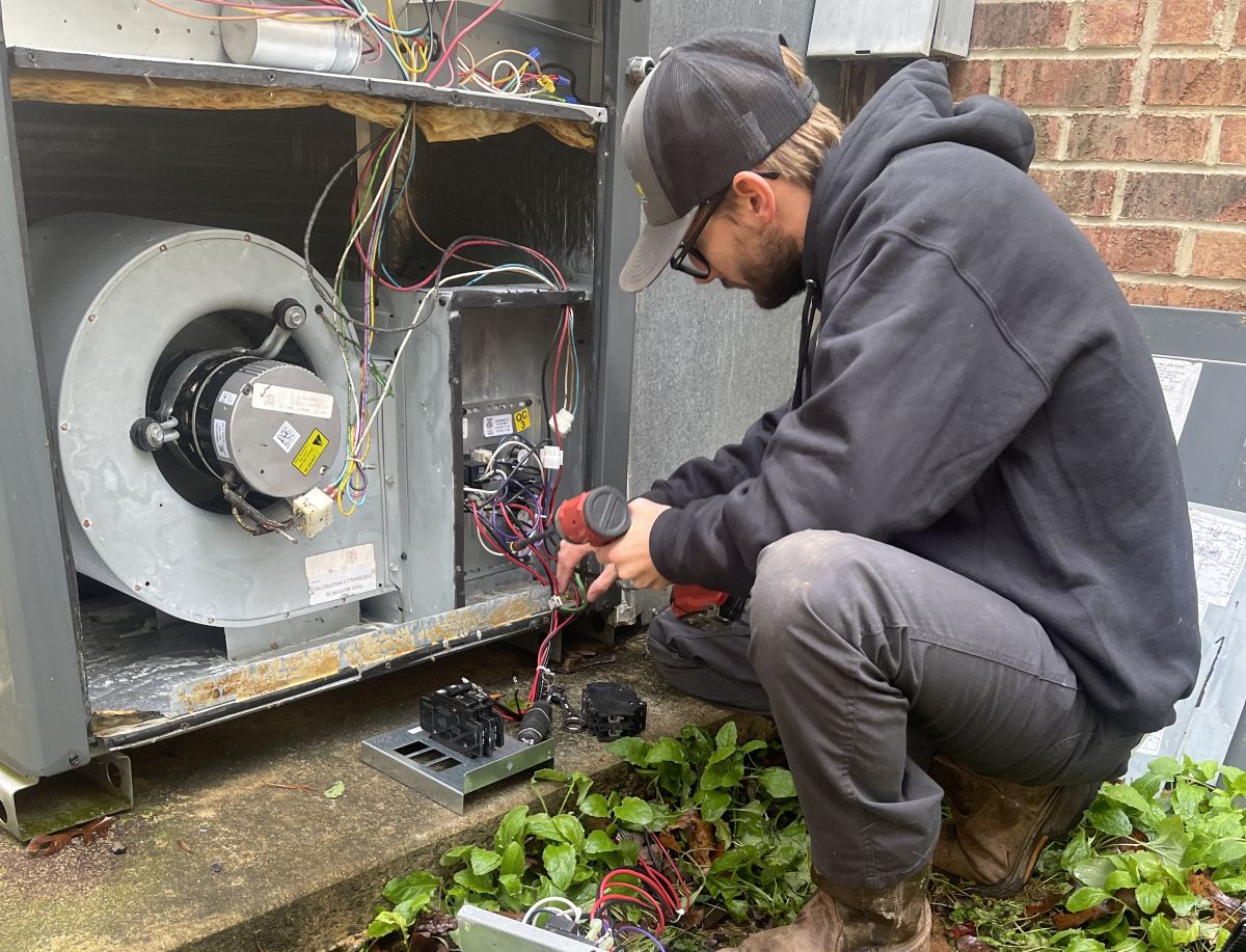 Panther HVAC technician repairing an HVAC system