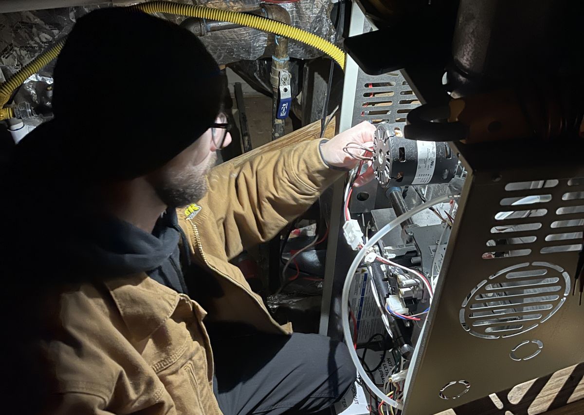 Panther HVAC team member repairing AC units