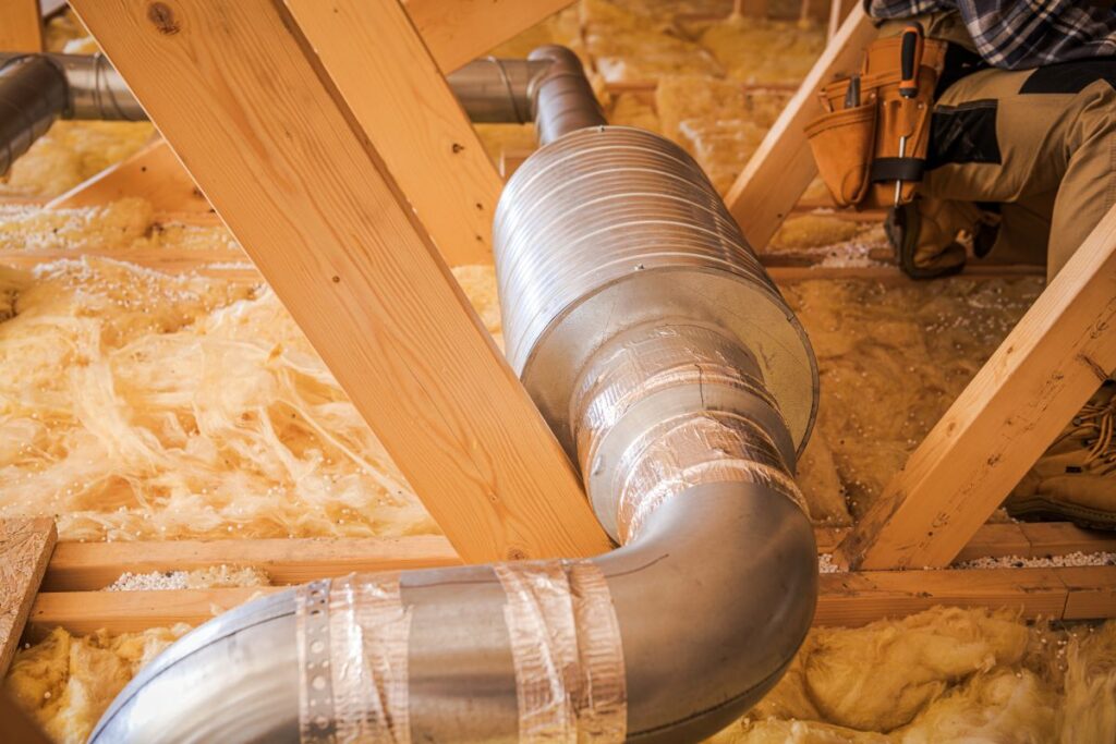 Installation of Ductwork in Residential Attic During Home Renovation Process