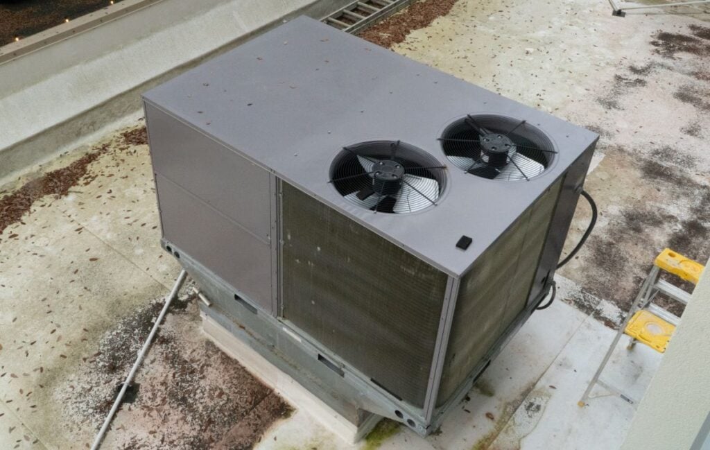 Large rooftop HVAC unit with dual fans provides essential climate control for commercial buildings