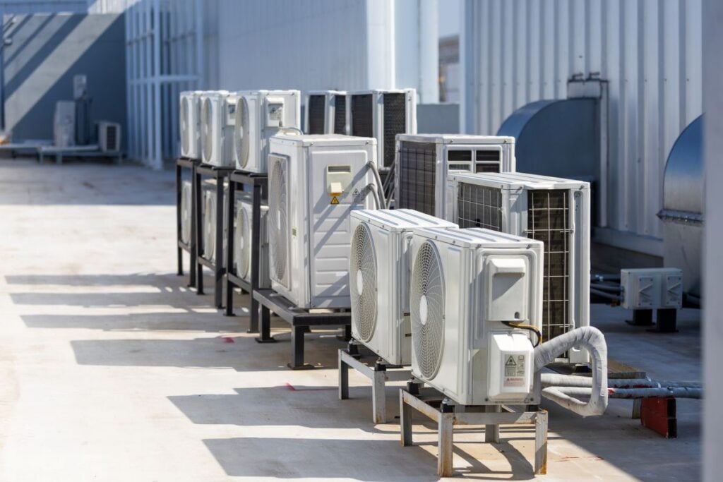 Row of industrial air conditioning units on a building rooftop. Rooftop HVAC Unit: How It Works and When to Replace It