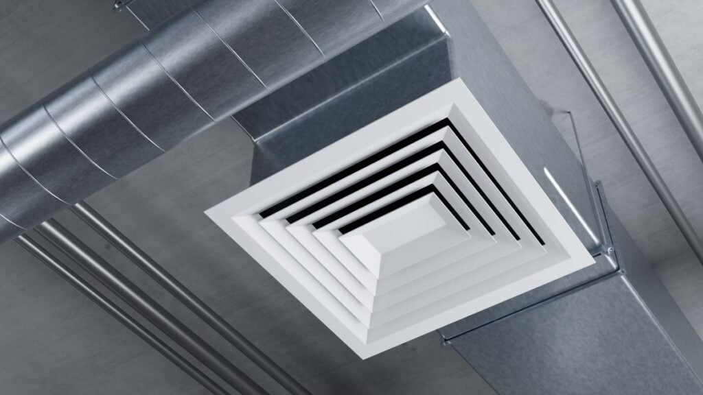 Ventilation installation, ceiling air diffuser connected to metal duct system distributes conditioned airflow inside commercial building