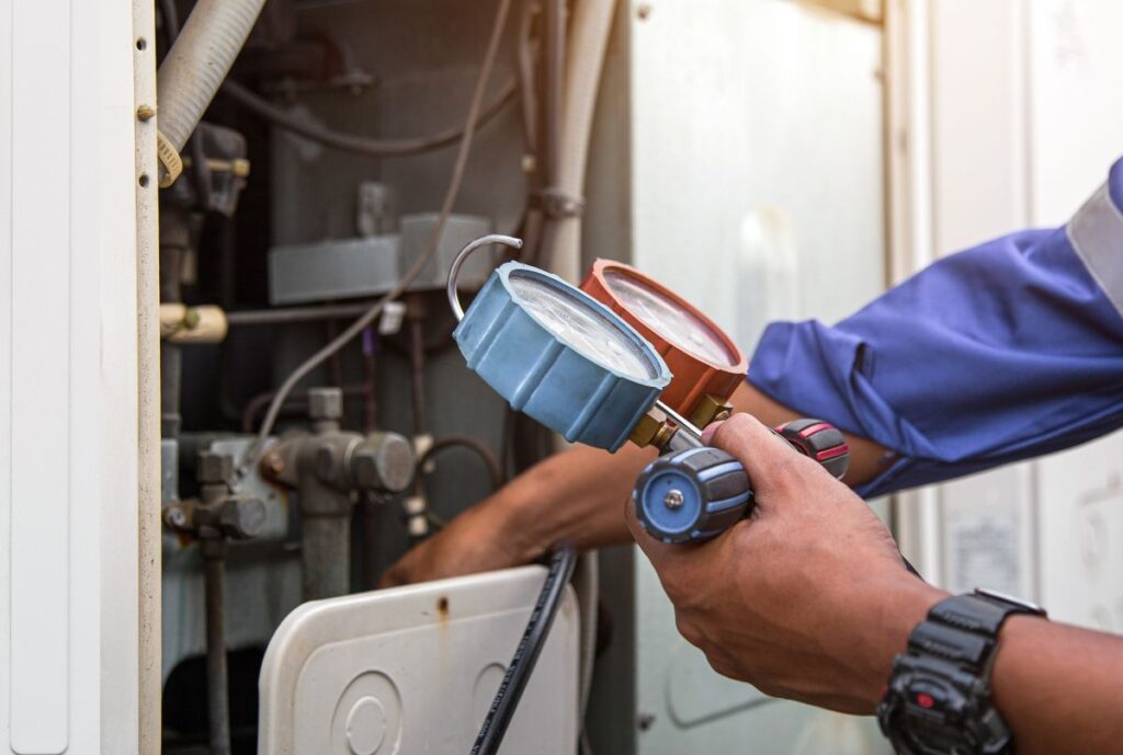 checking refrigerant and filling industrial air conditioner after duct cleaning maintenance outdoor compressor
